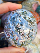 Load image into Gallery viewer, hand holding ocean jasper palm stone for meditation

