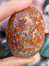 Load image into Gallery viewer, hand holding ocean jasper palm stone for meditation
