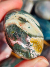 Load image into Gallery viewer, hand holding ocean jasper palm stone for meditation
