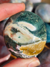 Load image into Gallery viewer, hand holding ocean jasper palm stone for meditation
